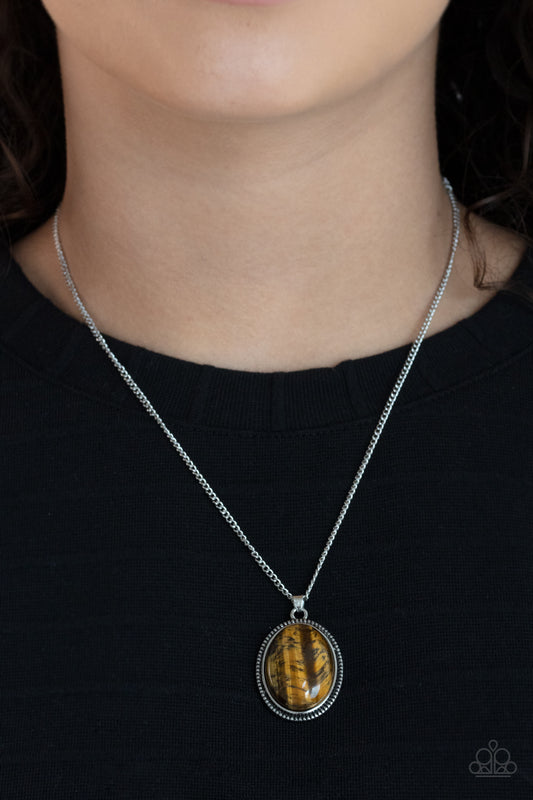 Tranquil Talisman Brown Necklace - Paparazzi Accessories. An oval tiger's eye stone is pressed into the center of a studded silver frame, creating a tranquil pendant below the collar. Features an adjustable clasp closure.  All Paparazzi Accessories are lead free and nickel free!  Sold as one individual necklace. Includes one pair of matching earrings.