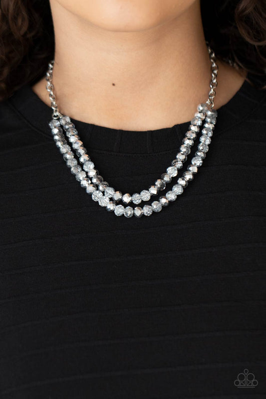 May The FIERCE Be With You Silver Necklace - Paparazzi Accessories. A sturdy silver chain connects double strands of silver and clear beads. The mirrored multi-faceted beads connect below the collar for a fiercely stunning style. Features an adjustable clasp closure.  All Paparazzi Accessories are lead free and nickel free!  Sold as one individual necklace. Includes one pair of matching earrings.