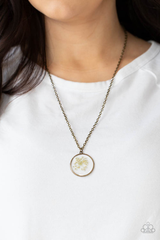 Tea Party Tease Brass Necklace - Paparazzi Accessories  A dainty white firework-like flower is encased inside a glassy frame, creating a whimsical pendant below the collar. Features an adjustable clasp closure.  All Paparazzi Accessories are lead free and nickel free!  Sold as one individual necklace. Includes one pair of matching earrings.