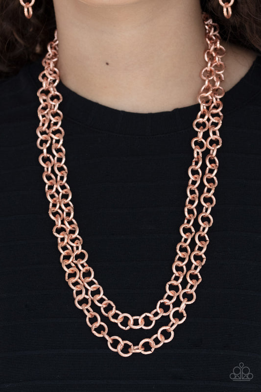 Grunge Goals Copper Necklace - Paparazzi Accessories  A seemingly infinite collection of textured shiny copper links connect into two dramatic rows across the chest, creating an intense industrial display. Features an adjustable clasp closure.  All Paparazzi Accessories are lead free and nickel free!  Sold as one individual necklace. Includes one pair of matching earrings.