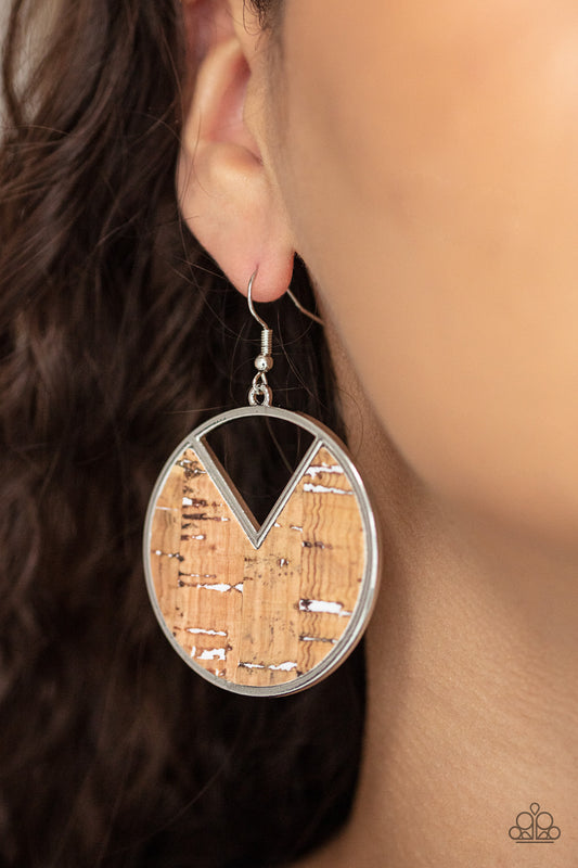 Nod to Nature White Earring - Paparazzi Accessories  Featuring hints of white accents, an earthy piece of cork is placed into the center of a circular hoop. A triangular slice is removed from the cork, creating an edgy airy finish. Earring attaches to a standard fishhook fitting.  Sold as one pair of earrings.