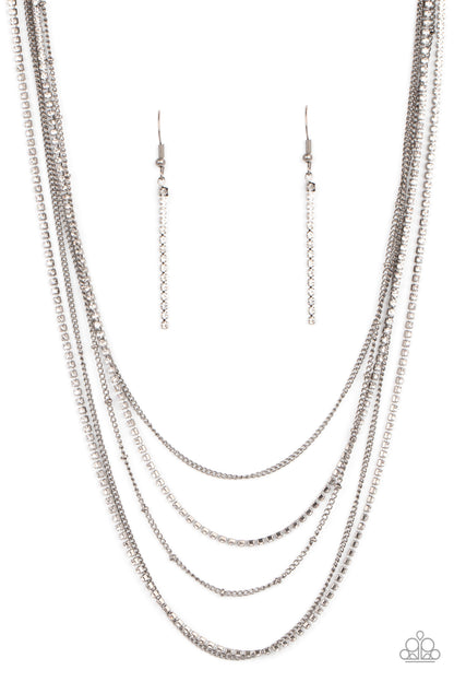 Dangerously Demure Black Necklace - Paparazzi Accessories  Dainty rows of classic gunmetal chain, gunmetal satellite chain, and strands of glassy white rhinestones, creating dazzling layers around the neck. Features an adjustable clasp closure.  All Paparazzi Accessories are lead free and nickel free!  Sold as one individual necklace. Includes one pair of matching earrings.