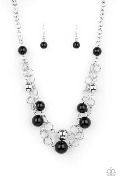 New Age Knockout Black Necklace - Paparazzi Accessories  Sections of oversized textured silver links, polished black and shiny silver beads haphazardly connect into two timeless layers below the collar, creating a dramatically refined display. Features an adjustable clasp closure.  Sold as one individual necklace. Includes one pair of matching earrings.