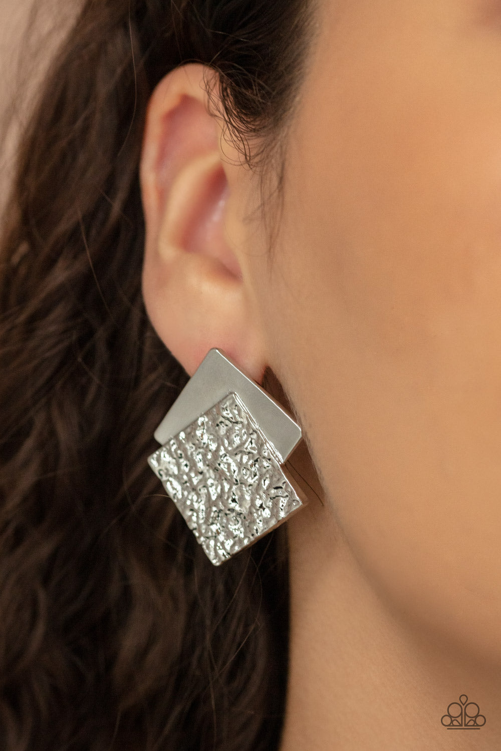 Square With Style Silver Post Earring - Paparazzi Accessories. Embossed in gritty textures, a rough silver square overlaps a plain silver square, creating a stacked frame. Earring attaches to a standard post fitting.  All Paparazzi Accessories are lead free and nickel free!  Sold as one pair of post earrings.