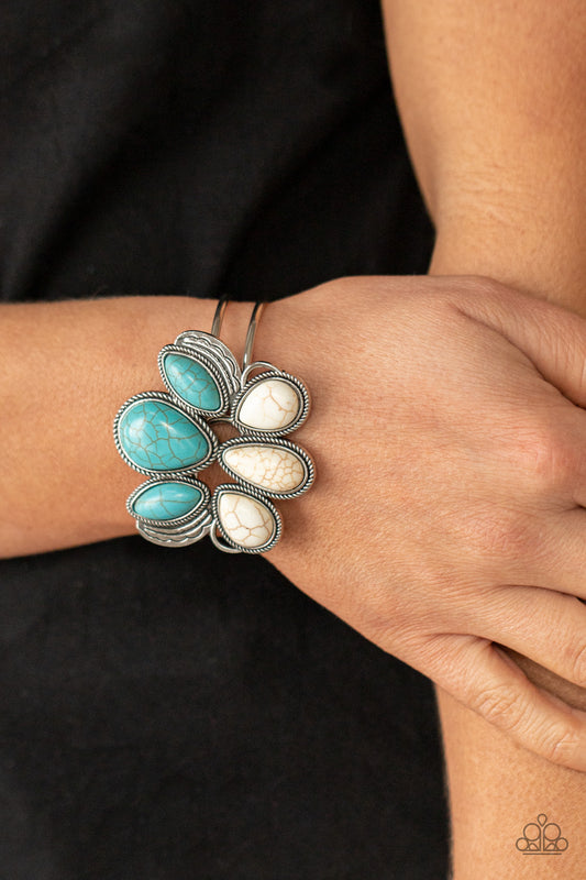Botanical Badlands White Cuff Bracelet - Paparazzi Accessories  Encased in rope-like silver accents, a series of oversized oval and teardrop turquoise and white stone frames stack into a lotus-like floral frame atop a layered silver cuff. Features a hinged closure.  All Paparazzi Accessories are lead free and nickel free!  Sold as one individual bracelet.