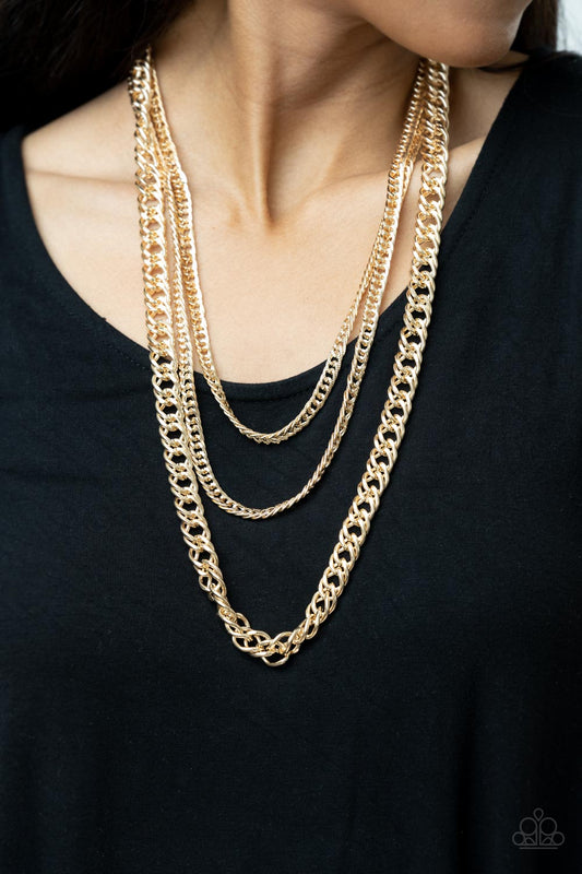 Chain of Champions Gold Necklace - Paparazzi Accessories  Bold layers of glistening gold chain of varying sizes and textures, fall like a weighty medal across the chest creating a shimmering industrial effect. Features an adjustable clasp closure.  All Paparazzi Accessories are lead free and nickel free!  Sold as one individual necklace. Includes one pair of matching earrings.