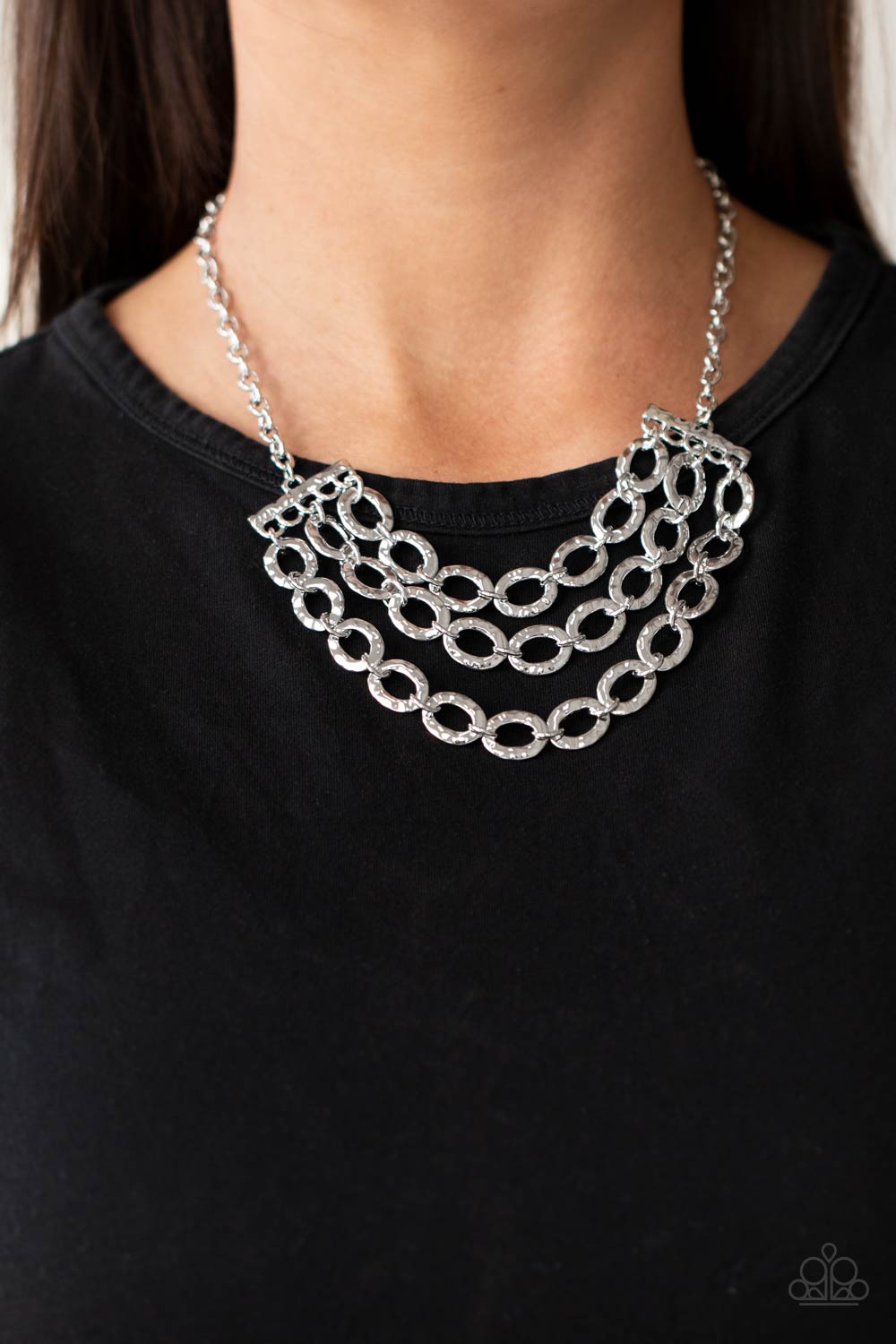 Repeat After Me Silver Necklace - Paparazzi Accessories  Three rows of shiny silver chains with oversized hammered oval links attach to silver bars for an edgy display below the collar. Features an adjustable clasp closure.  All Paparazzi Accessories are lead free and nickel free!   Sold as one individual necklace. Includes one pair of matching earrings.
