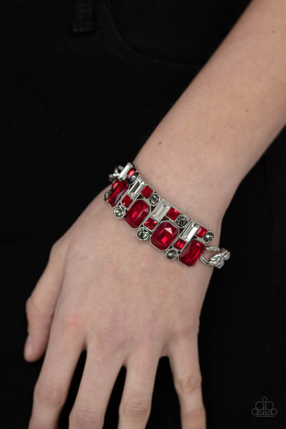 Urban Crest Red Bracelet - Paparazzi Accessories  A mismatched collision of red, smoky, and white rhinestone encrusted frames are threaded along a stretchy band that attaches to a chunky strand of silver chain, creating jaw-dropping dazzle across the front of the wrist.  All Paparazzi Accessories are lead free and nickel free!   Sold as one individual bracelet.