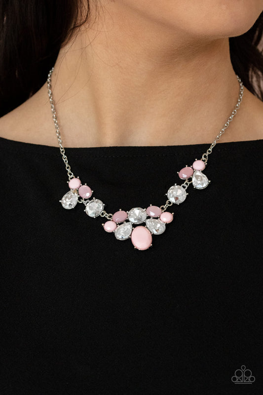 Ethereal Romance Pink Necklace - Paparazzi Accessories  Varying in opacity and shape, mismatched pink beads attach to oversized white rhinestones, creating bubbly frames that delicately link into an ethereal display below the collar. Features an adjustable clasp closure.  All Paparazzi Accessories are lead free and nickel free!  Sold as one individual necklace. Includes one pair of matching earrings.