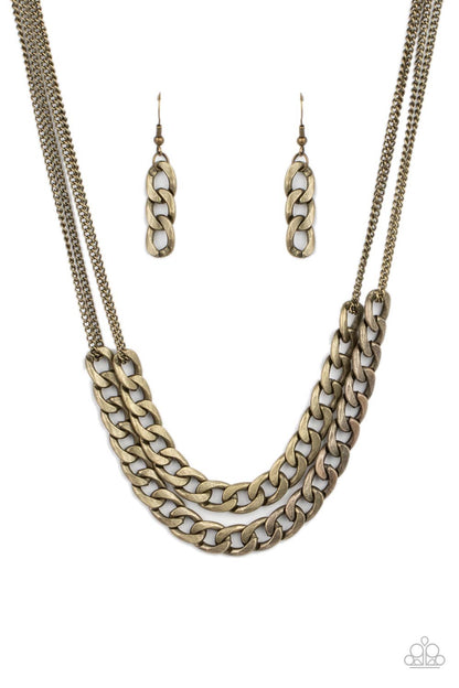 Urban Culture Brass Necklace - Paparazzi Accessories  Two sections of chunky brass curb chain attach to doubled brass chains below the collar, creating an intense industrial centerpiece. Features an adjustable clasp closure.  All Paparazzi Accessories are lead free and nickel free!  Sold as one individual necklace. Includes one pair of matching earrings.