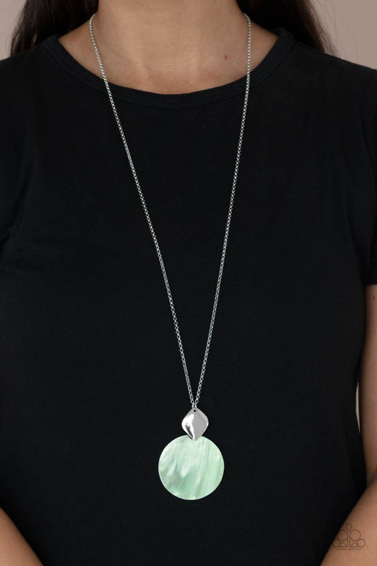 Tidal Tease Green Necklace - Paparazzi Accessories.  Featuring a glistening iridescence, an Green Ash shell-like disc attaches to a shiny silver frame at the bottom of a lengthened silver chain, creating a summery pendant. Features an adjustable clasp closure.  ﻿All Paparazzi Accessories are lead free and nickel free!  Sold as one individual necklace. Includes one pair of matching earrings.