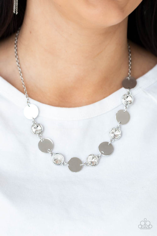 Refined Reflections White Necklace - Paparazzi Accessories  Shiny silver discs and oversized glassy white gems delicately link below the collar, creating a sparkly statement piece. Features an adjustable clasp closure.  All Paparazzi Accessories are lead free and nickel free!  Sold as one individual necklace. Includes one pair of matching earrings.