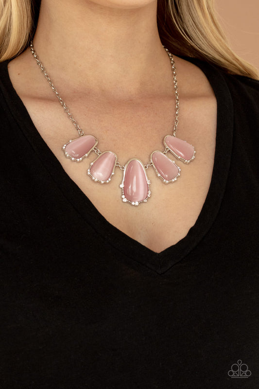 Newport Princess Pink Necklace - Paparazzi Accessories  A collection of asymmetrical pink cat’s eye stone teardrops are encased inside imperfect silver frames as they delicately link below the collar. The dainty silver frames are sporadically dotted in dainty silver studs and glassy white rhinestones, adding delicate sparkle to the ethereal display. Features an adjustable clasp closure.  All Paparazzi Accessories are lead free and nickel free!  Includes one pair of matching earrings.