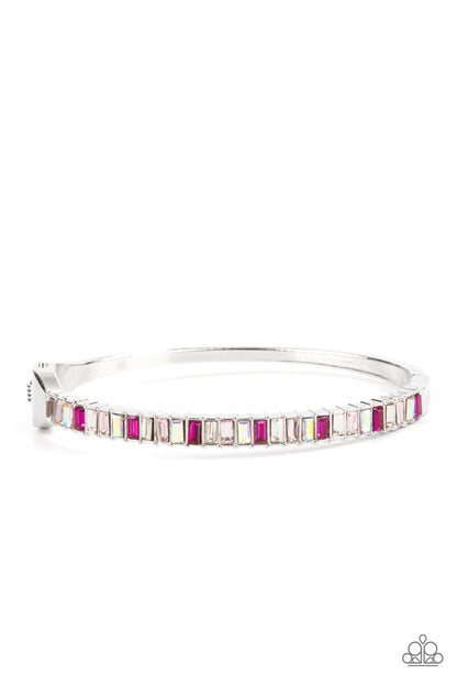 Toast to Twinkle Pink Hinge Bracelet - Paparazzi Accessories  Featuring regal emerald style cuts, a dainty row of pink and white rhinestones are encrusted across the front of a silver cuff-like bangle for a timeless fashion. Features a hinged closure.  Sold as one individual bracelet.