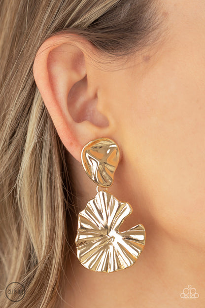 Empress Of The Amazon Gold Clip-On Earring - Paparazzi Accessories  A pair of shiny gold jungle leaves - one small, one large - fan out and dangle from the ear for a powerful Amazonian vibe. Earring attaches to a standard clip-on fitting.  Sold as one pair of clip-on earrings.