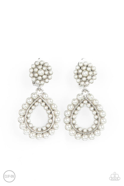 Discerning Droplets White Clip-On Earring - Paparazzi Accessories  Droplets of pearls dot the surface of a silver teardrop frame that suspends from a round pearl encrusted disc for a classic finish. Earring attaches to a standard clip-on fitting.  All Paparazzi Accessories are lead free and nickel free!  Sold as one pair of clip-on earrings.