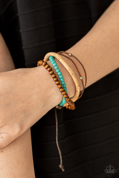 STACK To Basics Blue Urban Bracelet - Paparazzi Accessories  Featuring a strand of turquoise wooden beads, a collection of earthy strands of cork, leather, and wood, comes together for a simple handmade feel as it stacks up the wrist. Features an adjustable sliding knot closure.  All Paparazzi Accessories are lead free and nickel free!  Sold as one individual bracelet.