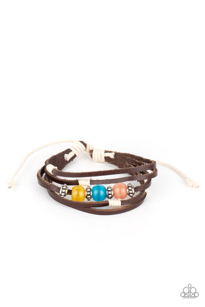 Homespun Radiance Multi Urban Bracelet - Paparazzi Accessories  Infused with studded silver accents, a row of Desert Mist, Blue Tint, and Illuminating cat's eye stone beads adorn the centermost strand of layered leather bands around the wrist for a colorful seasonal look. Features an adjustable sliding knot closure.  All Paparazzi Accessories are lead free and nickel free!  Sold as one individual bracelet.
