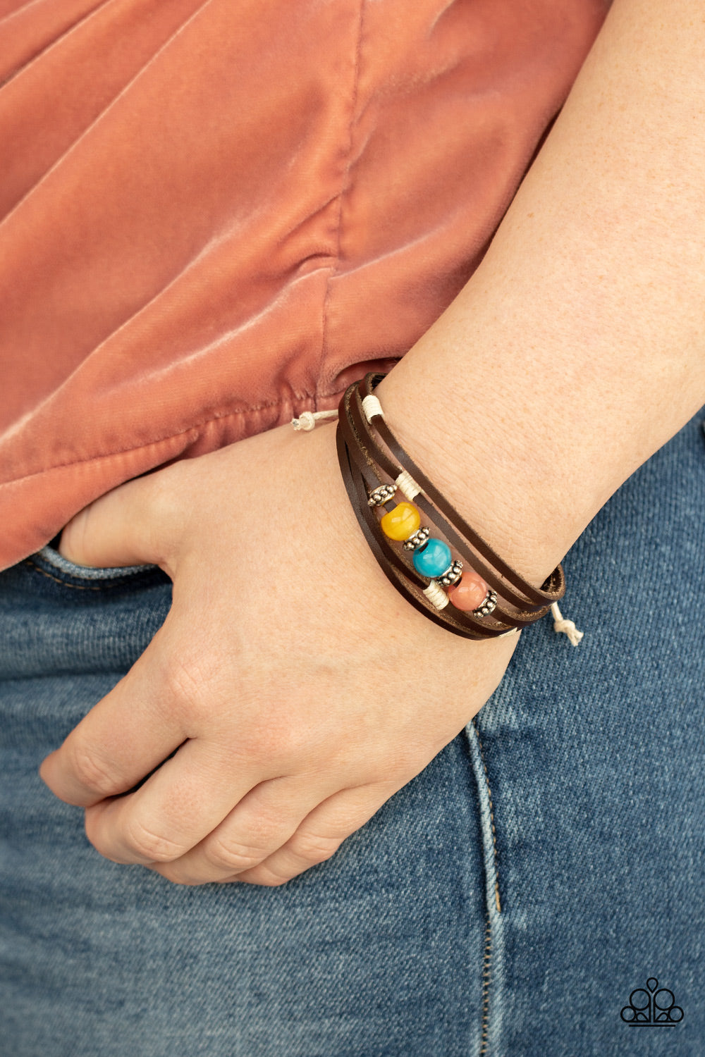 Homespun Radiance Multi Urban Bracelet - Paparazzi Accessories  Infused with studded silver accents, a row of Desert Mist, Blue Tint, and Illuminating cat's eye stone beads adorn the centermost strand of layered leather bands around the wrist for a colorful seasonal look. Features an adjustable sliding knot closure.  All Paparazzi Accessories are lead free and nickel free!  Sold as one individual bracelet.