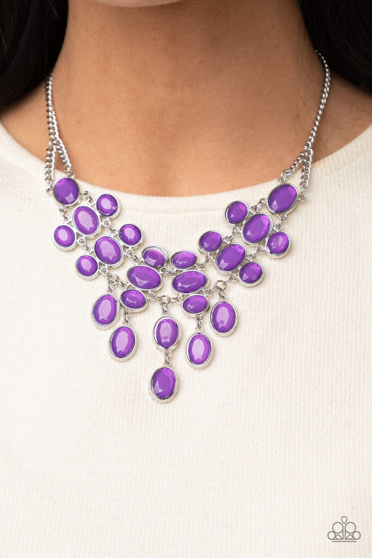 Serene Gleam Purple Necklace - Paparazzi Accessories   A stunning array of oval cut Amethyst Orchid gems, pressed into silver frames, interconnect into a spectacular princess-like bib design. The display rests just below the collar for an exquisitely serene gleam. Features an adjustable clasp closure.  All Paparazzi Accessories are lead free and nickel free!  Sold as one individual necklace. Includes one pair of matching earrings.