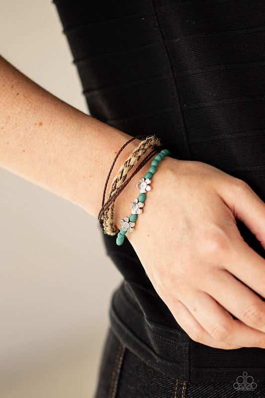 Raffia Remix Blue Bracelet - Paparazzi Accessories  Three delightful etched silver flowers stand out on a strand of turquoise wooden beads. Paired with an assortment of braided twine and cording, the set wraps around the wrist for an earthy remix. Features an adjustable sliding knot closure.  All Paparazzi Accessories are lead free and nickel free!  Sold as one individual bracelet.