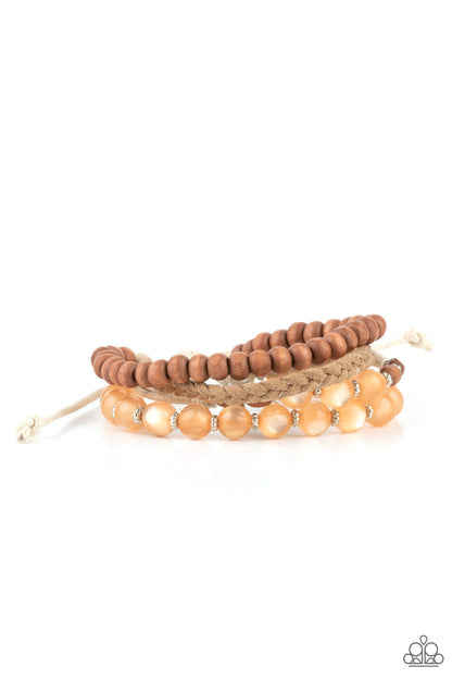 Down HOMESPUN Orange Urban Bracelet - Paparazzi Accessories  Strands of glassy orange cat's eye beads stand out in an earthy collection of wooden beads and braided twine, giving a polished flair to the natural homespun look as it stacks up the wrist. Features an adjustable sliding knot closure.  All Paparazzi Accessories are lead free and nickel free!  Sold as one individual bracelet.