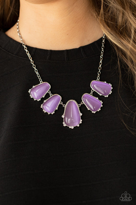 Newport Princess Purple Necklace - Paparazzi Accessories  A collection of asymmetrical Lavender cat’s eye stone teardrops are encased inside imperfect silver frames as they delicately link below the collar. The dainty silver frames are sporadically dotted in dainty silver studs and glassy white rhinestones, adding delicate sparkle to the ethereal display. Features an adjustable clasp closure.  All Paparazzi Accessories are lead free and nickel free! Includes one pair of matching earrings.