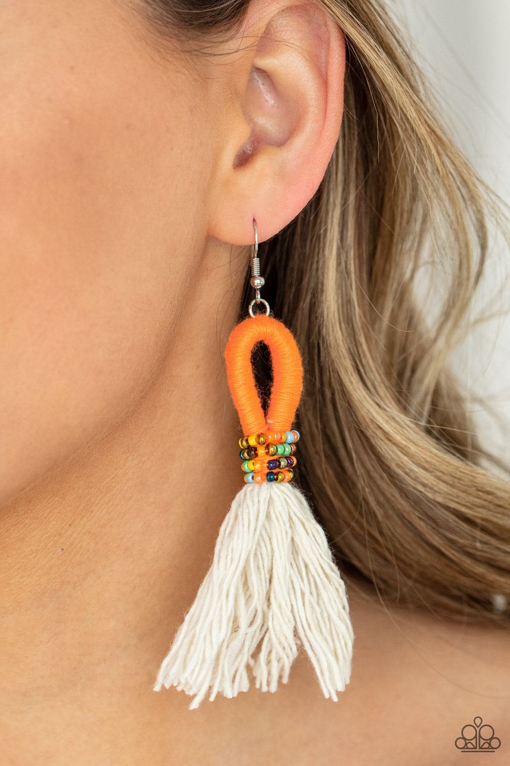 The Dustup Orange Earring - Paparazzi Accessories  A tassel of soft white cotton fans out under rows of brightly colored seed beads. Anchored by a loop of vibrant orange floss, the eye-catching style swings from the ear for a show-stopping statement. Earring attaches to a standard fishhook fitting.  All Paparazzi Accessories are lead free and nickel free!  Sold as one pair of earrings.