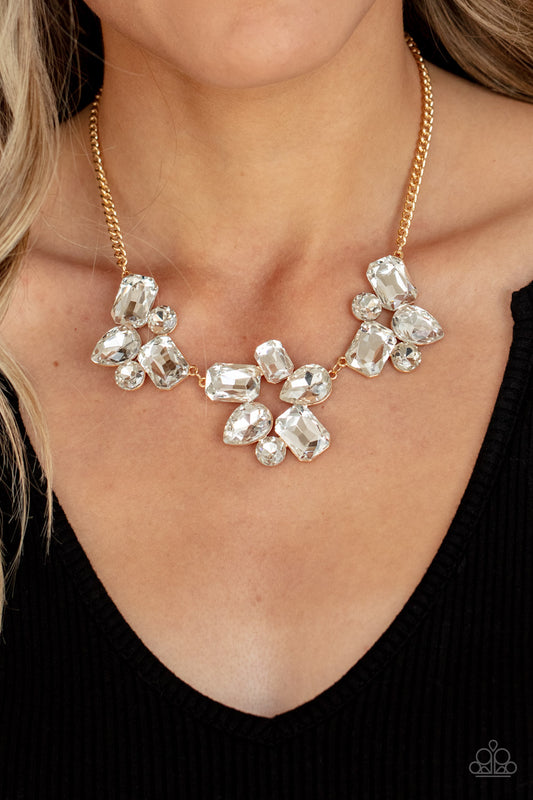 Galactic Goddess Gold Necklace - Paparazzi Accessories  An unexpected explosion of oversized round, teardrop, and emerald cut rhinestones cluster into haphazard groupings. The blinding clusters link together, creating a stellar statement piece that sits below the collar. Features an adjustable clasp closure.  All Paparazzi Accessories are lead free and nickel free!  Sold as one individual necklace. Includes one pair of matching earrings.