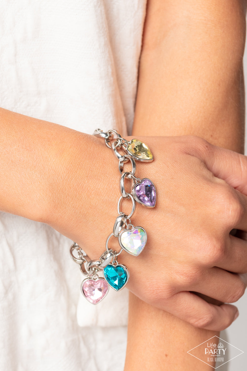 Candy Heart Charmer Multi Bracelet - Paparazzi Accessories  Multicolored heart-shaped gems are encased in sleek silver frames that swing from an oversized silver chain, creating a sparkly fringe around the wrist. Features an adjustable clasp closure. Due to its prismatic palette, color may vary.  Sold as one individual bracelet.  P9RE-MTXX-073XX