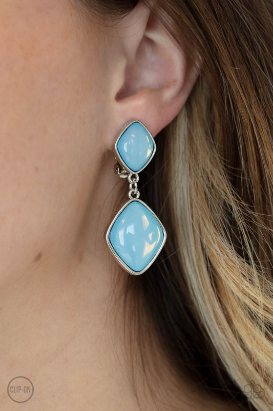 Double Dipping Diamonds Blue Clip-On Earring - Paparazzi Accessories  A pair of diamond shaped Cerulean opals are pressed into the centers of rustic silver frames that link into an ethereal lure. Earring attaches to a standard clip-on fitting.  All Paparazzi Accessories are lead free and nickel free!  Sold as one pair of clip-on earrings.