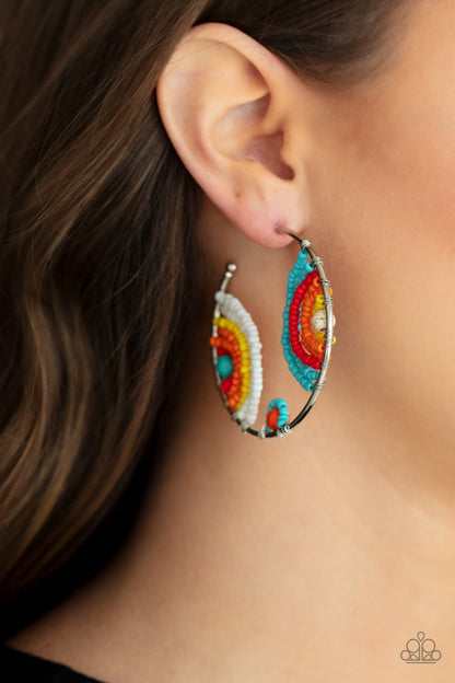 Rainbow Horizons Multi Earring - Paparazzi Accessories  Rows of turquoise, red, orange, yellow, and white seed beads curl around turquoise, orange, and white stone centers, creating colorful rainbows inside a delicate wire wrapped hoop. Hoop measures approximately 2" in diameter. Earring attaches to a standard post fitting.  All Paparazzi Accessories are lead free and nickel free!  Sold as one pair of hoop earrings.