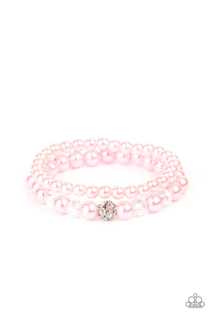 Cotton Candy Dreams Pink Bracelet - Paparazzi Accessories  A collection of dainty pink pearls and glassy crystal-like beads are threaded along two stretchy bands around the wrist, creating timeless layers. A white rhinestone encrusted silver bead adorns the center of one bracelet, creating a sparkly centerpiece.  Sold as one pair of bracelets.