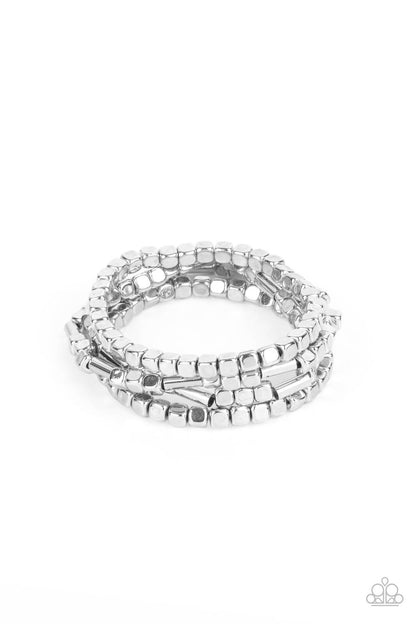 Metro Materials Silver Bracelet - Paparazzi Accessories. Lightweight and flirty, two strands of silver square beads interspersed with silver cylinders, are paired with two strands of silver cubes. The four stretchy bracelets come together to create an irresistible stack of metallic mayhem.  All Paparazzi Accessories are lead free and nickel free!  Sold as one set of four bracelets.