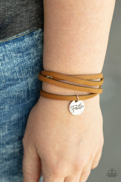 Wonderfully Worded Brown Wrap Bracelet - Paparazzi Accessories  A hammered silver disc stamped in the word, "Faith" is threaded on a lengthened brown leather cord that triple wraps around the wrist, creating a message of hope. Features an adjustable clasp closure.  All Paparazzi Accessories are lead free and nickel free!  Sold as one individual bracelet.