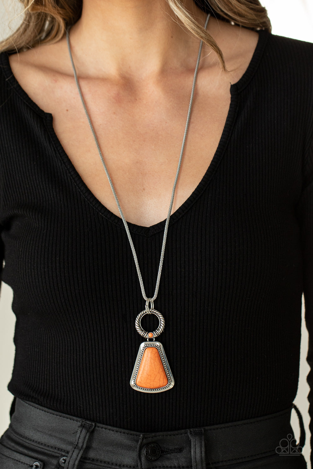 Stone Prairies Orange Necklace - Paparazzi Accessories  A flared triangular orange stone is pressed into the center of a studded silver frame. A textured ring, dotted with a dainty orange stone, links to the top of the stone creating a dramatically earthy pendant at the bottom of a lengthened round mesh chain. Features an adjustable clasp closure.  All Paparazzi Accessories are lead free and nickel free!  Sold as one individual necklace. Includes one pair of matching earrings.
