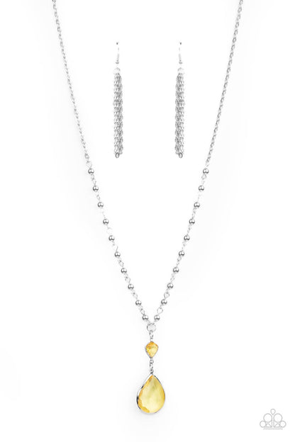 Titanic Splendor Yellow Necklace - Paparazzi Accessories  A magnificent Primrose teardrop gem steals the show as it dangles brilliantly from a lengthened silver chain. A small heart-shaped Primrose gem and shiny round beads accentuate the majestic look. Features an adjustable clasp closure.  All Paparazzi Accessories are lead free and nickel free!  Sold as one individual necklace. Includes one pair of matching earrings.