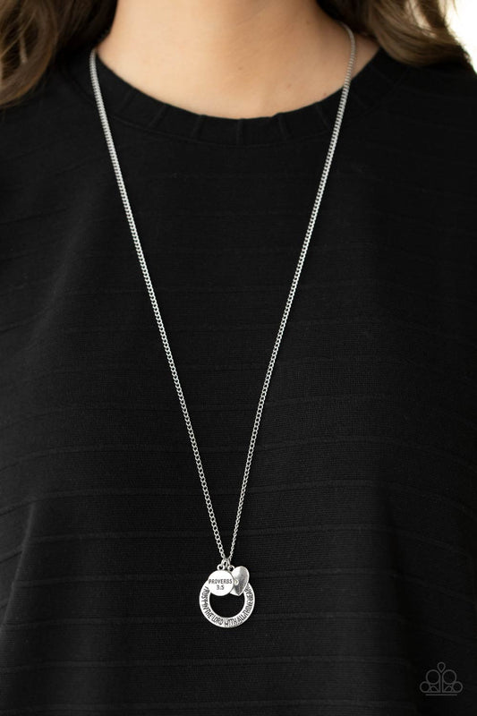 Full of Faith Multi Necklace - Paparazzi Accessories  Dotted with a sparkly iridescent rhinestone, a dainty silver heart joins a silver ring stamped in the biblical passage, "Trust in the Lord with all thine heart," and a silver disc stamped in, "Proverbs 3:5," along the bottom of a lengthened silver chain, creating an inspirational pendant. Features an adjustable clasp closure.  Sold as one individual necklace. Includes one pair of matching earrings.
