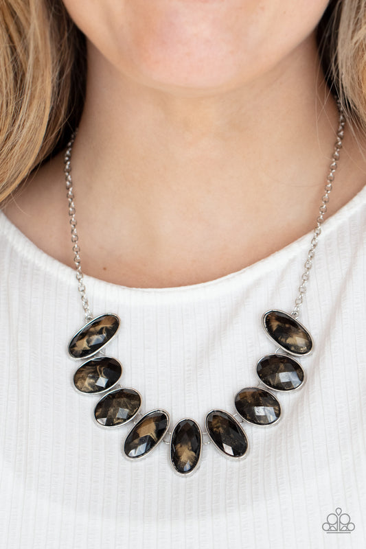 Elliptical Episode Black Necklace - Paparazzi Accessories  Generous glossy black gems, dusted in shimmery gold, lay in silver oval frames and link across the collar creating a glimmering statement. Features an adjustable clasp closure.  All Paparazzi Accessories are lead free and nickel free!  Sold as one individual necklace. Includes one pair of matching earrings.