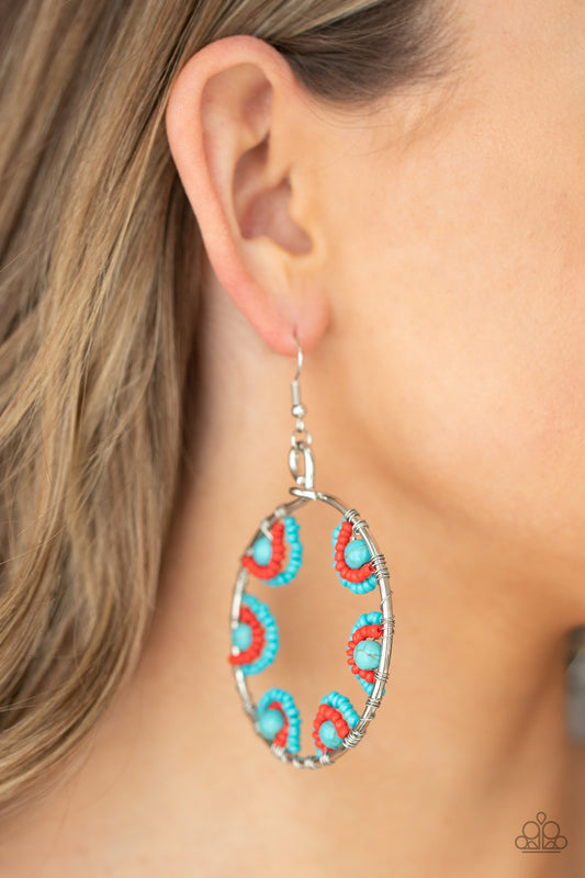 Off The Rim Blue Earring - Paparazzi Accessories  Red and turquoise seed beads are threaded on wires and looped over turquoise stones on the inside of a spacious silver hoop. The pattern makes its way around the inside of the circle for an around-the-world air. Earring attaches to a standard fishhook fitting.  All Paparazzi Accessories are lead free and nickel free!  Sold as one pair of earrings.