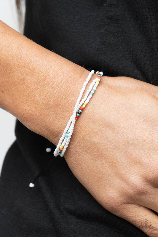 Basecamp Boyfriend White Urban Bracelet - Paparazzi Accessories  Two strands of dainty white seed beads, highlighted with a strand of brightly colored beads, form a simple accent around the wrist. Features an adjustable sliding knot closure.  All Paparazzi Accessories are lead free and nickel free!  Sold as one individual bracelet.