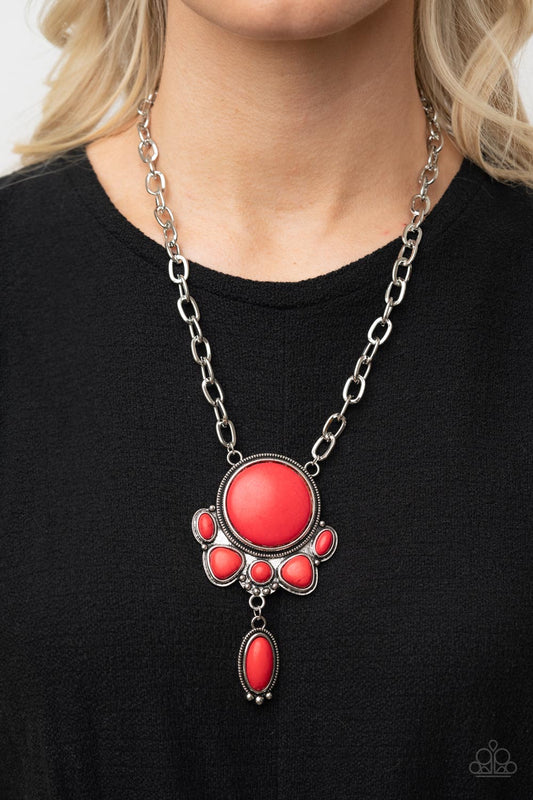 Geographically Gorgeous Red Necklace- Paparazzi Accessories  A large red stone encased in a studded silver frame swings dramatically from a heavy silver chain with oversized links. A collection of red stones wraps around the bottom of the large pendant, with an elongated oval stone swaying below them. Features an adjustable clasp closure.  Sold as one individual necklace. Includes one pair of matching earrings.  Get The Complete Look!  Bracelet: "Eco-Friendly Fashionista - Red" (Sold Separately)