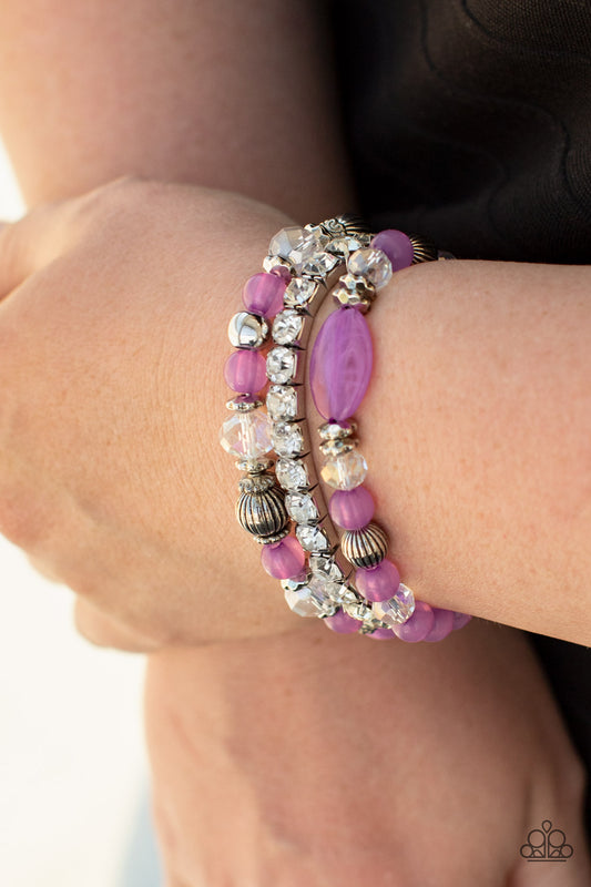 Ethereal Etiquette Purple Bracelet - Paparazzi Accessories  Infused with a stretchy strand of glassy white rhinestones, a mismatched collection of cloudy Amethyst Orchid, white crystal-like, and ornate silver accents are threaded along stretchy bands around the wrist, creating ethereal layers.  All Paparazzi Accessories are lead free and nickel free!  Sold as one set of three bracelets.