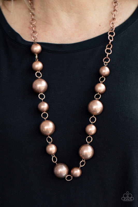 Commanding Composure Copper Necklace - Paparazzi Accessories  An oversized collection of intense copper beads boldly link below the collar, creating a dramatic industrial display. Features an adjustable clasp closure.  All Paparazzi Accessories are lead free and nickel free!  Sold as one individual necklace. Includes one pair of matching earrings.