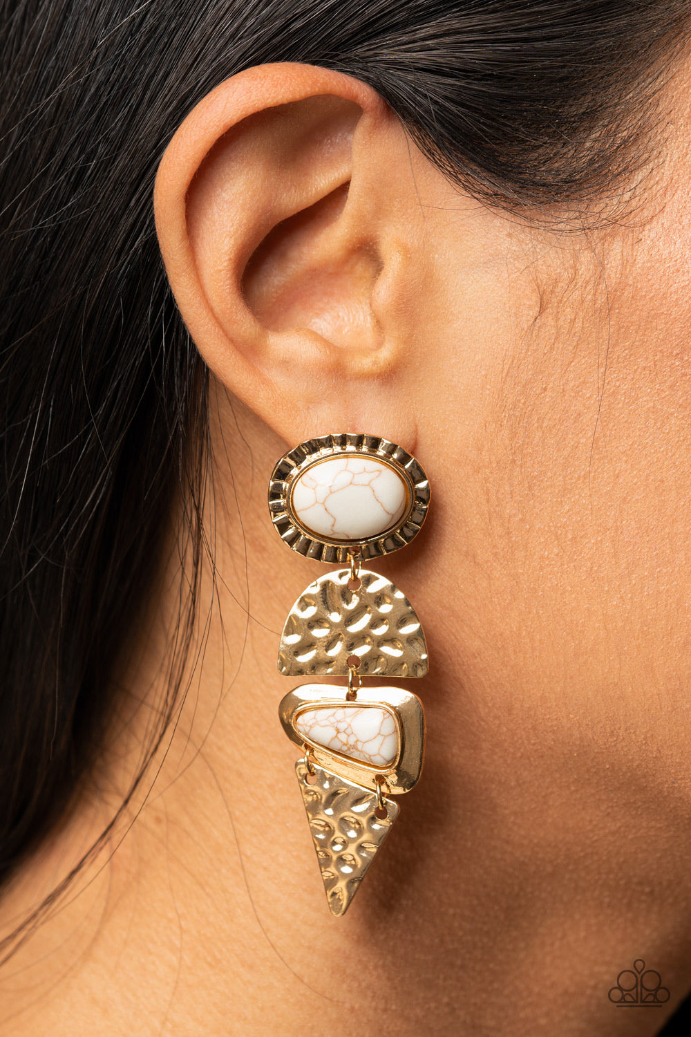 Earthy Extravagance Gold Post Earring - Paparazzi Accessories  Dotted with oval and triangular white stone accents, mismatched gold frames alternate with hammered geometric gold plates, creating an elegantly earthy lure. Earring attaches to a standard post fitting.  All Paparazzi Accessories are lead free and nickel free!   Sold as one pair of post earrings.