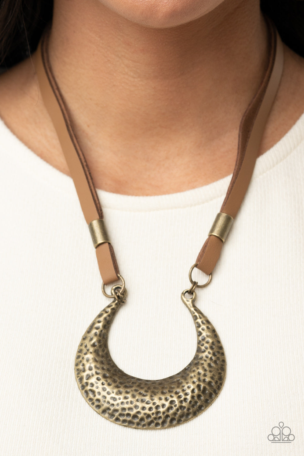 Majorly Moonstruck Brass Necklace - Paparazzi Accessories  Infused with antiqued brass beads, strips of brown leather link to an oversized half moon pendant that is hammered in a bold brass finish, creating a rustic statement piece below the collar. Features an adjustable clasp closure.  All Paparazzi Accessories are lead free and nickel free!  Sold as one individual necklace. Includes one pair of matching earrings.