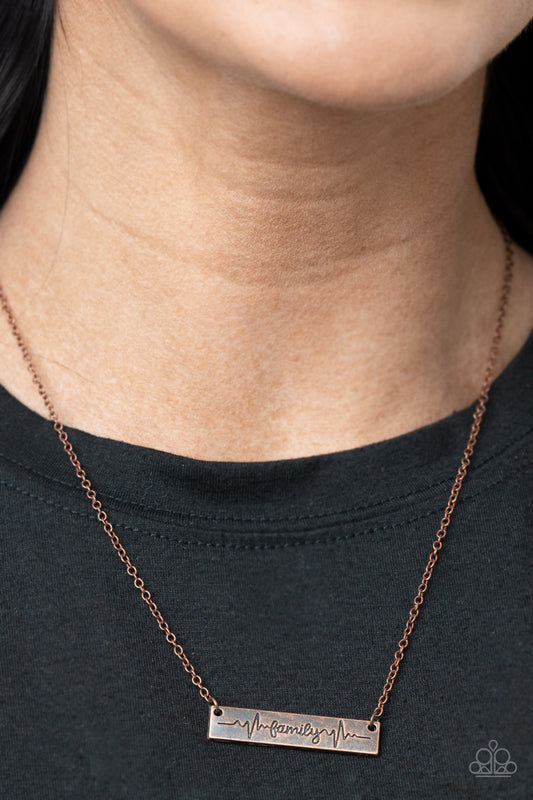 Living The Mom Life Copper Necklace - Paparazzi Accessories  The word "Family," is inscribed between symbolic life lines on a rectangular copper plate creating an affectionate keepsake on a dainty copper chain below the collar. Features an adjustable clasp closure.  Sold as one individual necklace. Includes one pair of matching earrings.