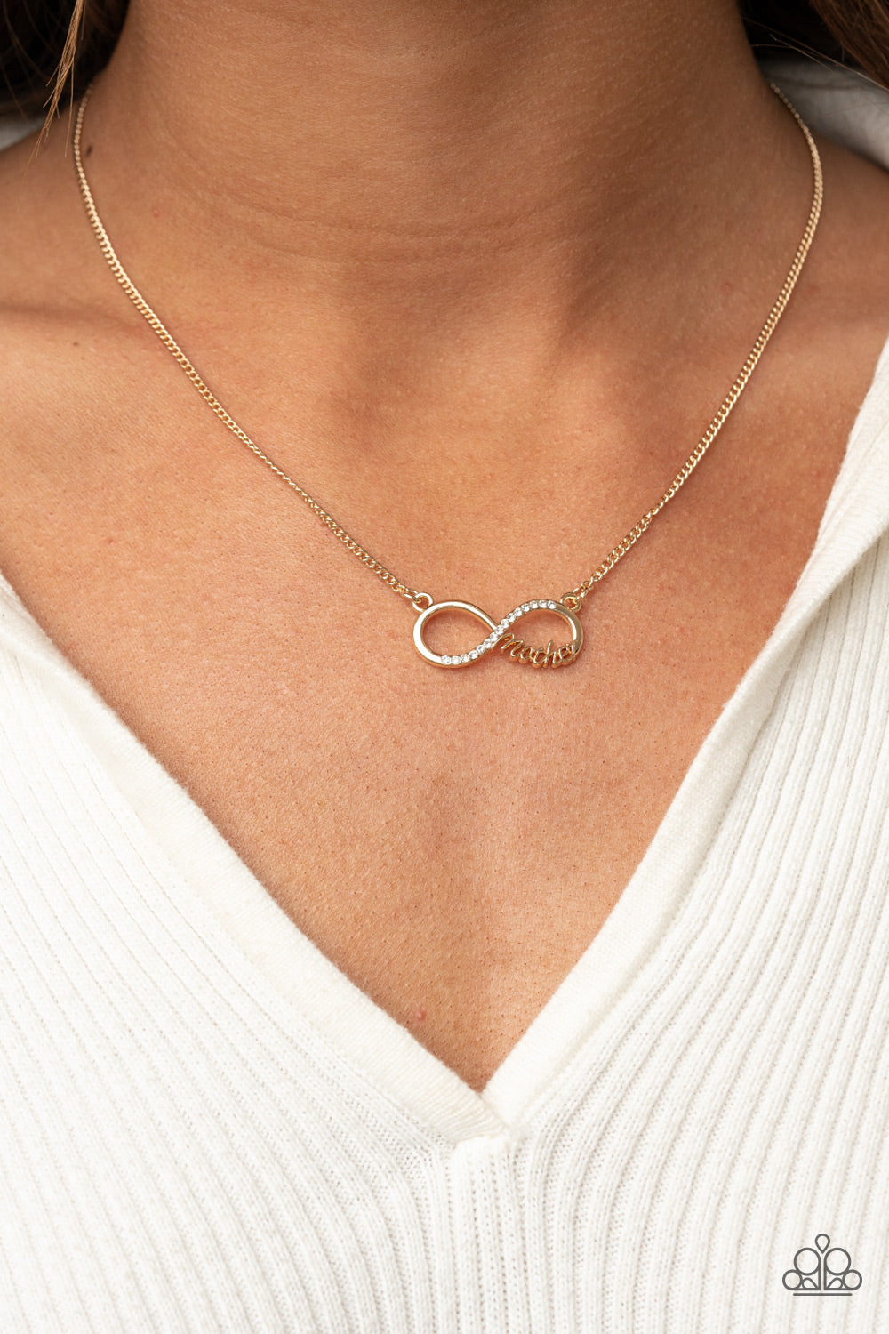 Forever Your Mom Gold Necklace - Paparazzi Accessories  A bright gold infinity symbol features the word "Mother" in filigree script across the bottom. A row of sparkly dainty rhinestones travels across the curve creating a lovingly charming sentiment as it connects to a dainty gold chain below the collar. Features an adjustable clasp closure.  Sold as one individual necklace. Includes one pair of matching earrings.