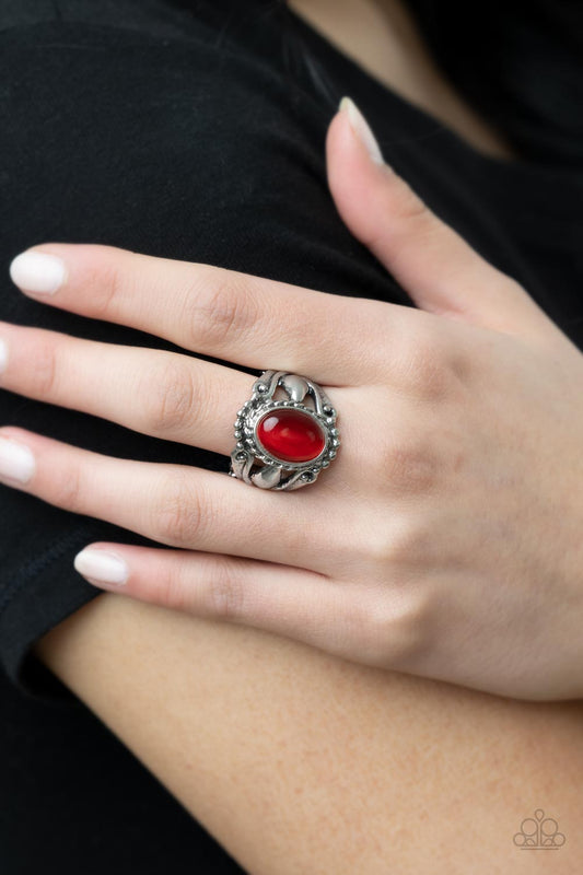 Jubilant Gem Red Ring - Paparazzi Accessories  A polished red cat's eye stone creates a jubilant statement as it rests inside a studded silver frame atop an airy pedestal like band. Features a stretchy band for a flexible fit.  Sold as one individual ring.