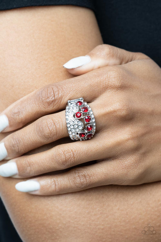 Imperial Incandescence Red Ring - Paparazzi Accessories  Encased in sleek silver fittings, a cluster of glittery red rhinestones coalesce inside an airy silver band encrusted in haphazard sections of glassy white rhinestones for a modern fashion. Features a stretchy band for a flexible fit.  Sold as one individual ring.